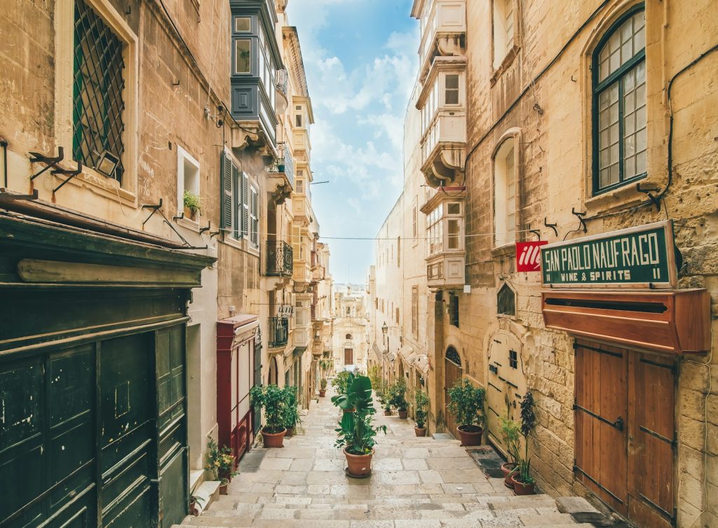 concrete street under blue sky during daytime valetta malta