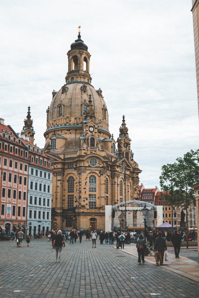 people walking near brown concrete building during daytime Dresden